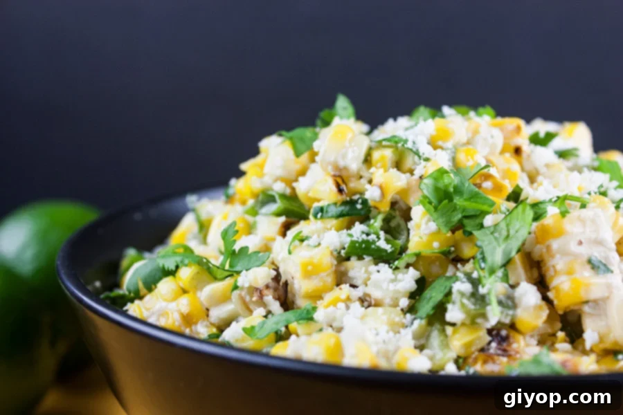 side view closeup of the Grilled Mexican Street Corn Salad in a black bowl