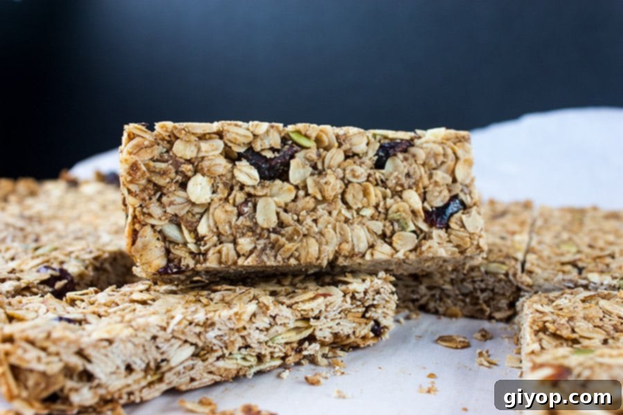Delicious Homemade Granola Bars stacked neatly on a white plate, showcasing their perfect texture and readiness for a healthy snack.