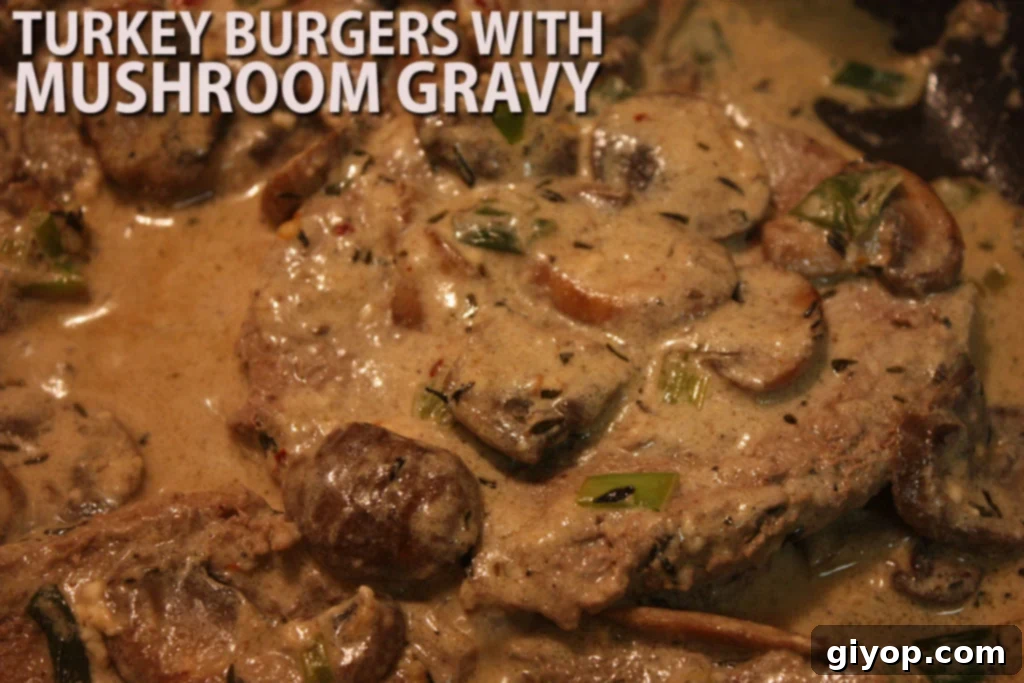 Juicy Turkey Burgers smothered in a rich mushroom gravy, served alongside fresh green onions.